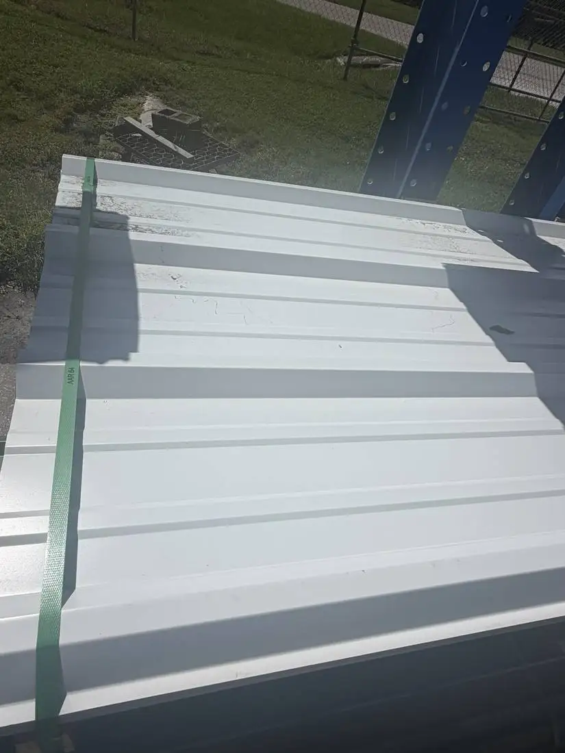 Bundle of white PBR metal roof panels at the FL Sheet Metal warehouse